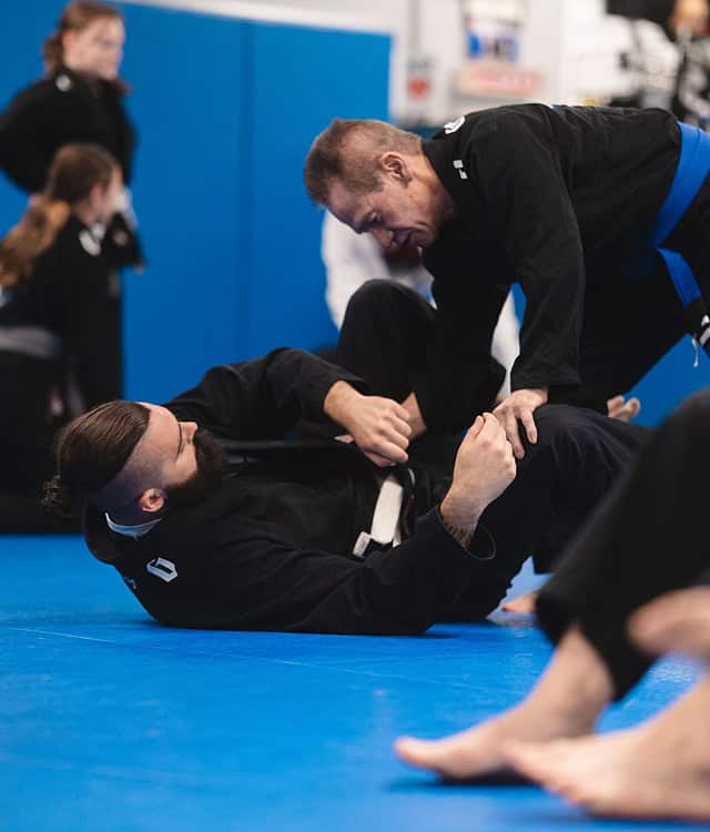 Two practitioners practicing Brazilian Jiu-Jitsu techniques at Legacy Jiu-Jitsu Academy.