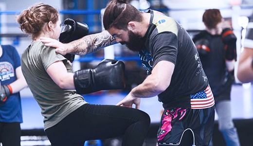 Instructor practicing self-defense techniques with a student at Legacy Jiu-Jitsu Academy.