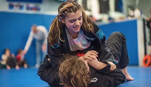 Teen girl practicing Jiu-Jitsu techniques at Legacy Jiu-Jitsu Academy.