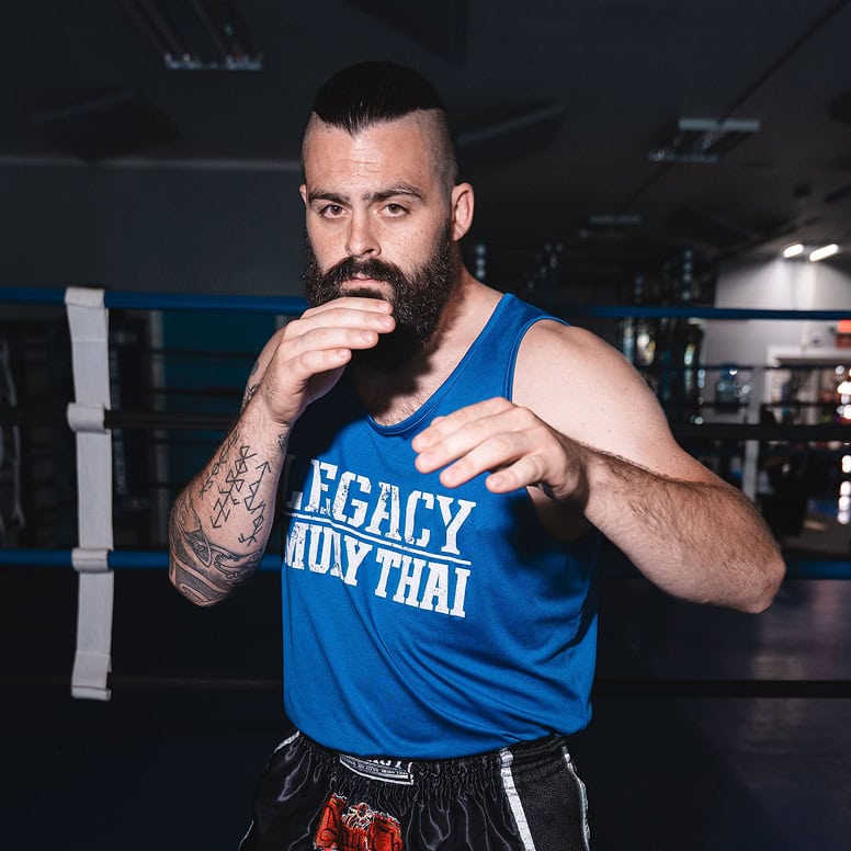 Man practicing martial arts at Legacy Jiu-Jitsu Academy, focusing on technique and discipline.