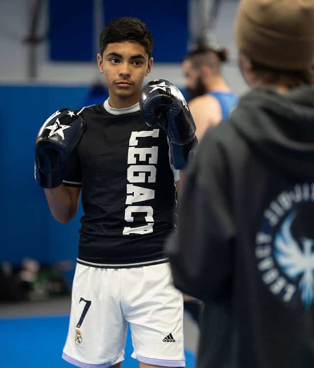 Young male martial artist practicing boxing at Legacy Jiu-Jitsu Academy.