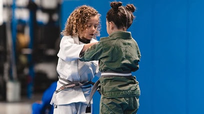 Young children practicing Brazilian Jiu-Jitsu techniques at Legacy Jiu-Jitsu Academy.