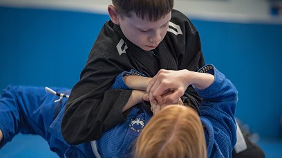 Children practicing martial arts techniques during kids class at Legacy Jiu-Jitsu Academy.