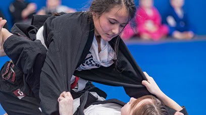 Young girl practicing martial arts techniques during a class at Legacy Jiu-Jitsu Academy.